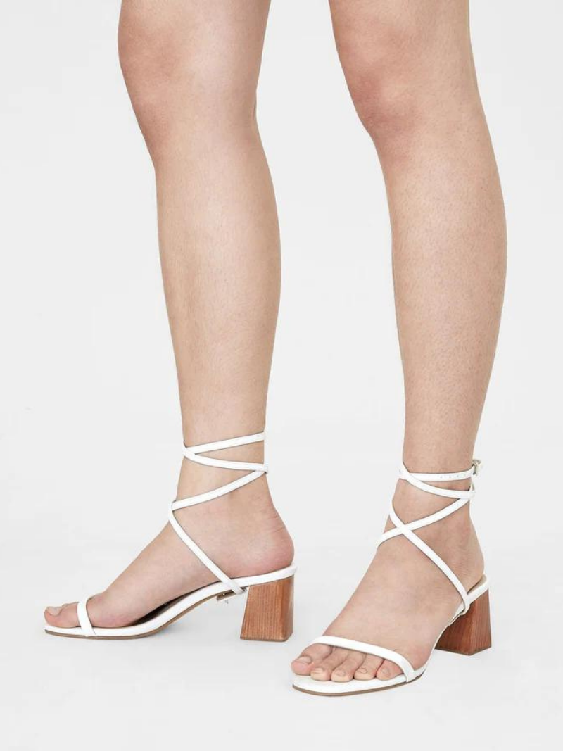 Close up of women wooden block heels with freeform front crossing ankle straps