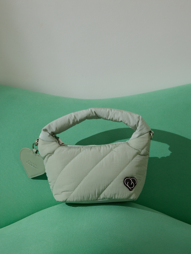 Light Pastel Green colour cushion bag on sofa