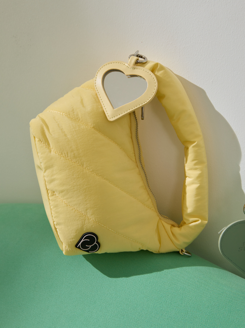 Cushion light pastel yellow ladies handbag wit heart-shaped mirror detail