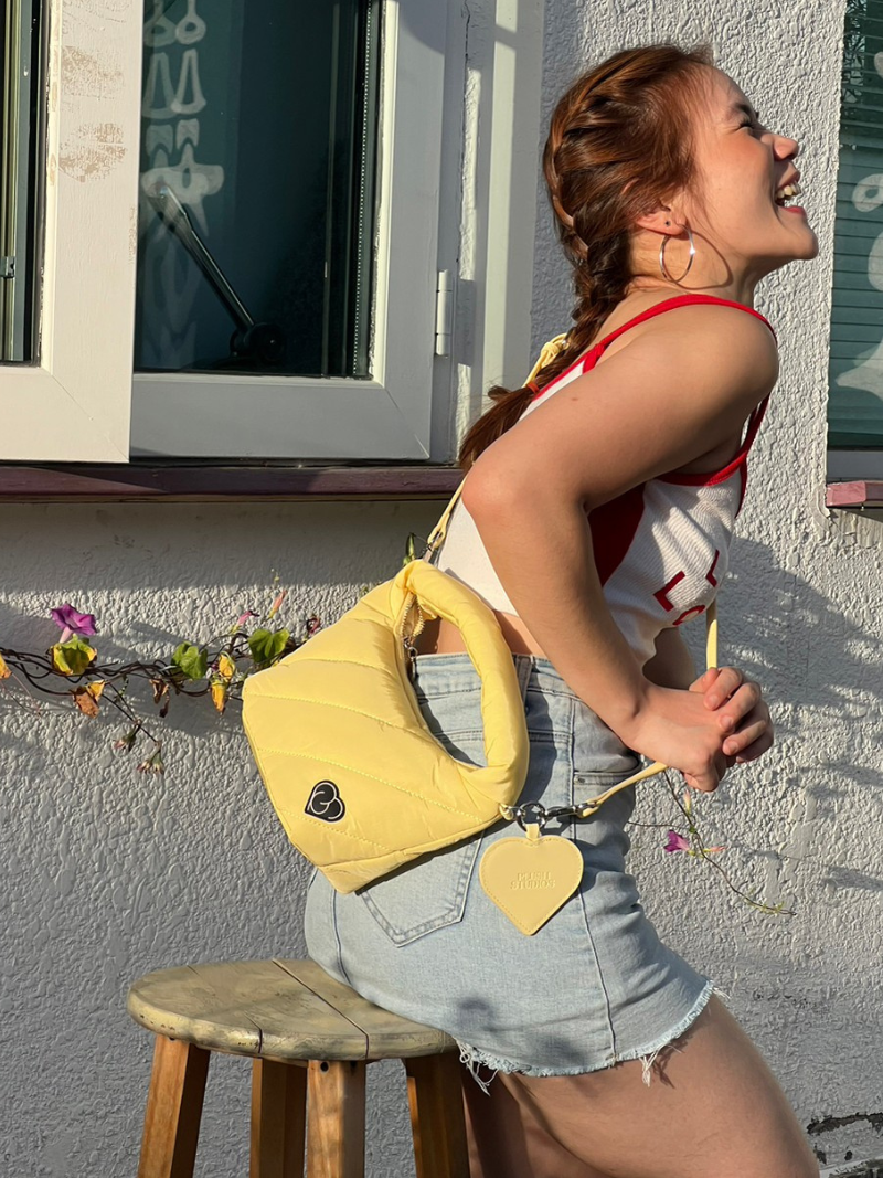 Cushion light yellow female handbag in slide-sling