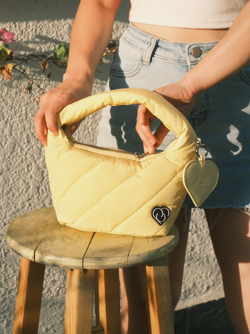 Cushion pastel yellow female handbag with zip detail