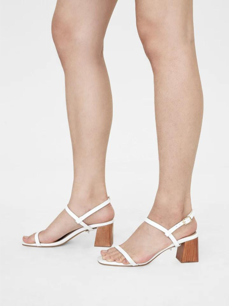 Close up of white women heels with slingback straps