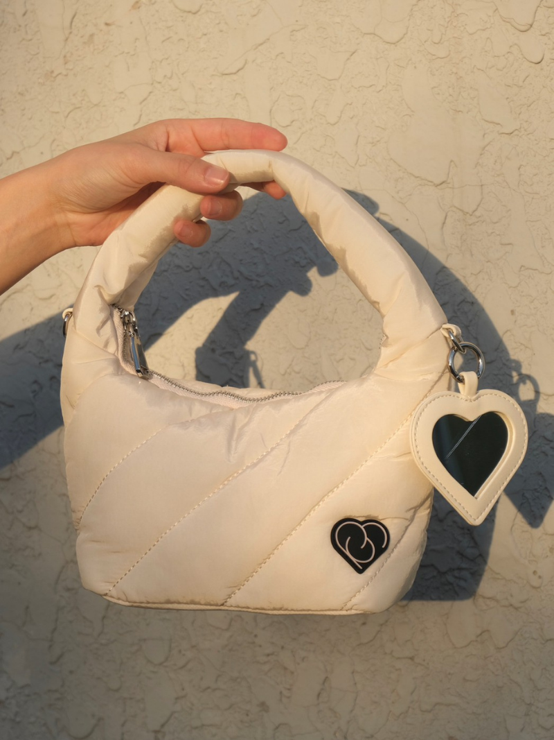 White coloured ladies handbag close up view